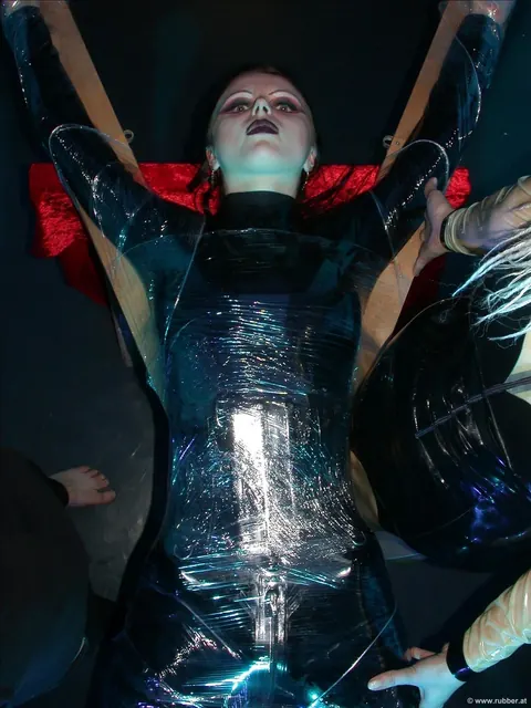 Two Women in Latex Kiss While Bound in Bondage – photo 13 of 16