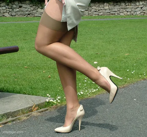 Woman in a Skirt and High Heels Poses Outdoors – photo 16 of 16