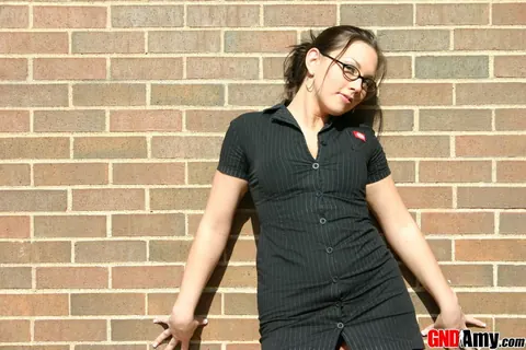 Thick Woman in Glasses Strips to Lingerie by Brick Wall – photo 1 of 12