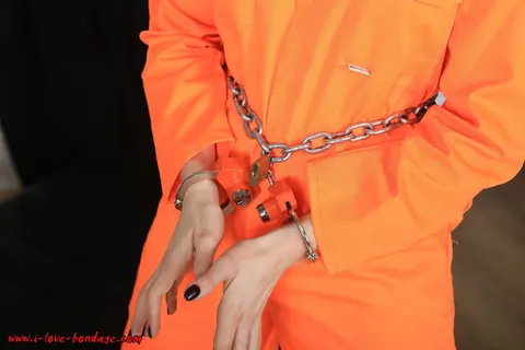Brunette in Pigtails Spreads Her Legs While Cuffed in an Orange Jumper – photo 4 of 16