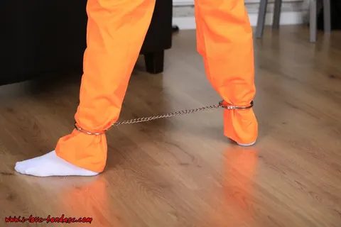 Brunette in Pigtails Spreads Her Legs While Cuffed in an Orange Jumper – photo 3 of 16