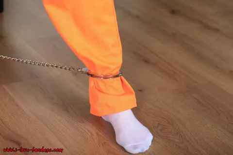 Brunette in Pigtails Spreads Her Legs While Cuffed in an Orange Jumper – photo 6 of 16