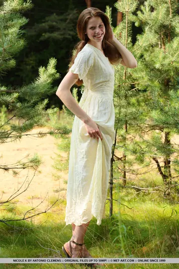 Pale Redhead Undresses Among Saplings Outdoors