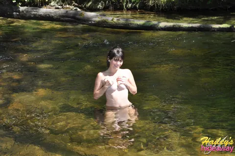Busty Tattooed Brunette Strips Out of Her Bikini by the River – photo 8 of 12