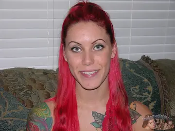 Busty Redhead with Tattoos Spreads Her Pierced Pussy