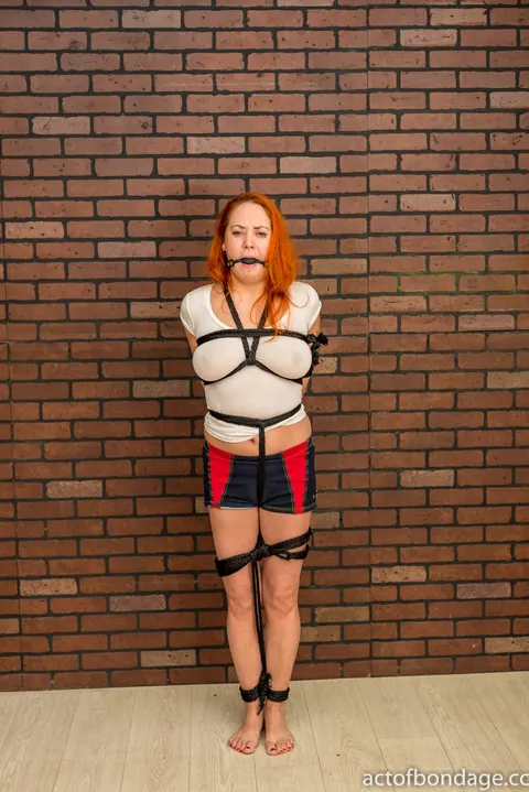 Busty Redhead Bound and Gagged in Shorts Spreads and Shows Her Feet – photo 5 of 12