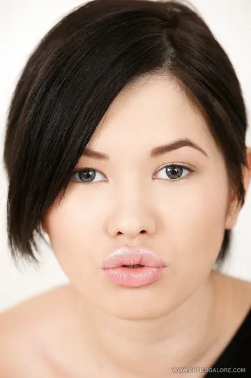 Asian Brunette Strips and Uses a Dildo