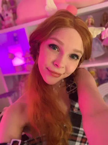 Tall Redhead in Pigtails Strips Out of Her Fishnet Lingerie