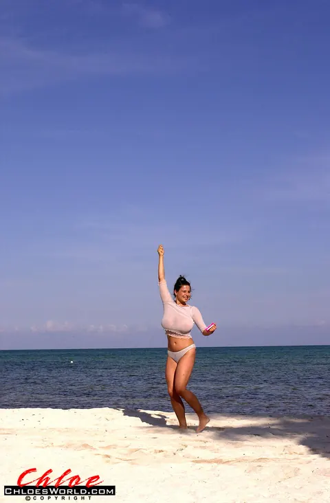 Chloe Vevrier: Thick Brunette MILF in Pigtails Strips Out of Her Bikini on the Beach – photo 1 of 16