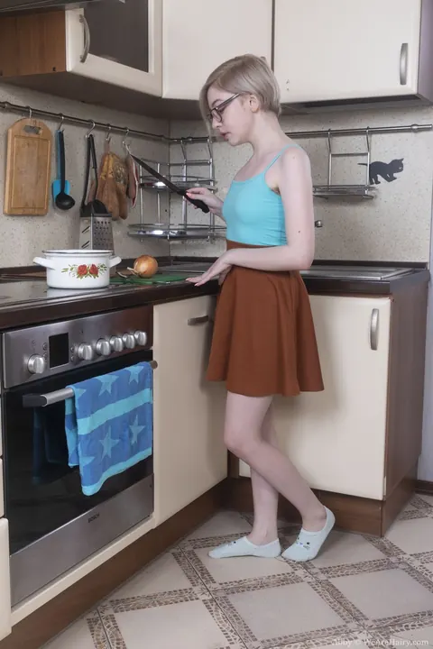 Short-Haired Blonde in Socks and Glasses Spreads in the Kitchen – photo 1 of 21