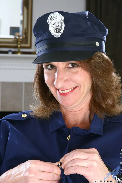 Redhead MILF Strips Out of Her Police Uniform in Stockings – photo 2 of 21