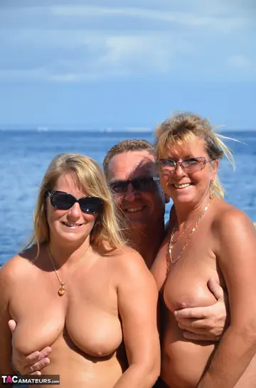 Petra Wegat – Two Curvy MILFs in Glasses Share a Man in a Threesome on the Beach