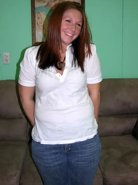 Zoie Starr: Curvy Redhead MILF Strips Out of Her Jeans and Spreads on the Sofa – photo 6 of 20