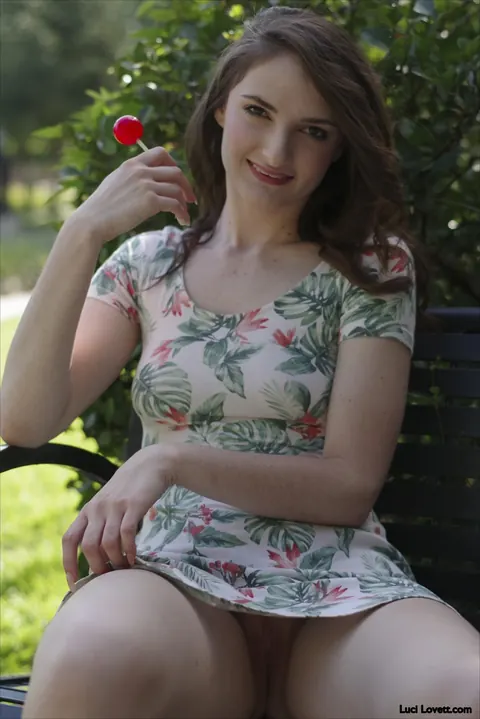 Luci Lovett: Brunette Flashes Her Pussy in a Skirt While Eating a Lollipop Outdoors – photo 4 of 15