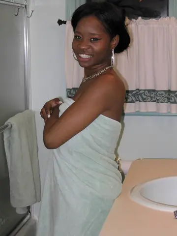 Petite Ebony Brunette Shows Her Big Tits and Spreads in the Bathroom