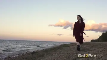Brunette Pisses and Spreads in a Skirt and Boots on the Beach