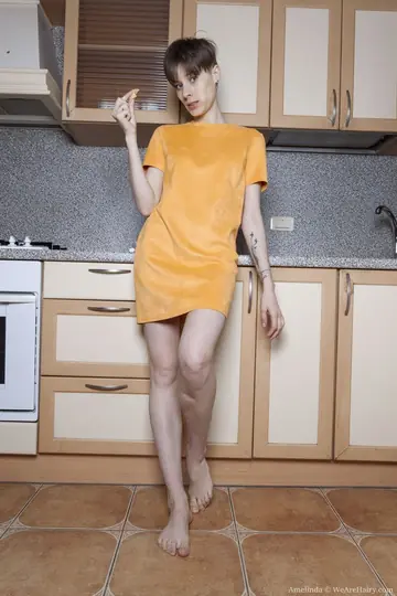 Amelinda – Short-Haired Brunette Reveals Her Hairy Bush and Armpits in the Kitchen