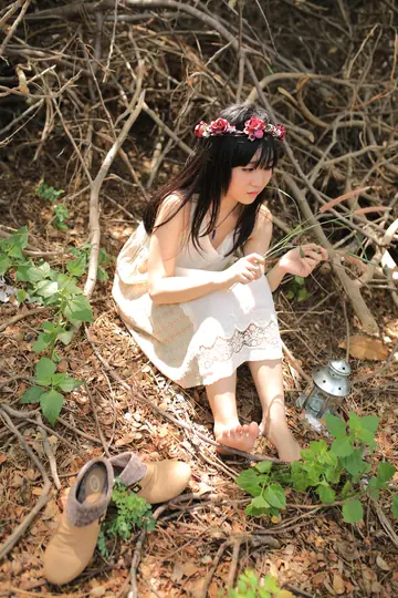 Petite Asian Woman Poses in a White Dress Outdoors