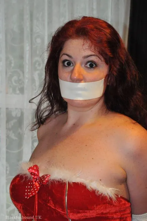 Redhead MILF with Big Natural Tits Bound and Gagged in Leather for Xmas – photo 13 of 16