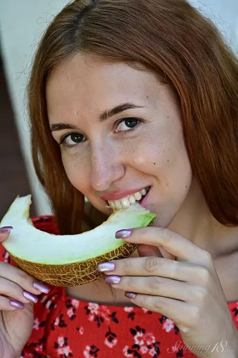 Thick Redhead Strips Out of Her Skirt and Heels While Eating Melon – photo 8 of 16