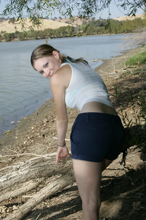 Petite Russian Woman Poses in a Bikini and Shorts on the Beach – photo 2 of 20