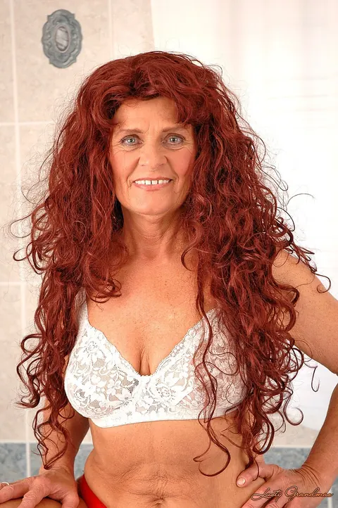 Mature Redhead Strips and Shows Her Hairy Pussy in the Bathroom – photo 2 of 16