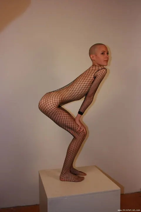 Skinny Shaved-Head Model Shows Her Pussy in Fishnet Pantyhose – photo 10 of 16