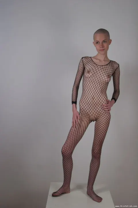 Skinny Shaved-Head Model Shows Her Pussy in Fishnet Pantyhose – photo 4 of 16