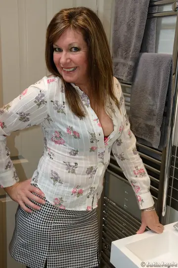Mature Blonde MILF Spreads Her Shaved Pussy in the Bathroom