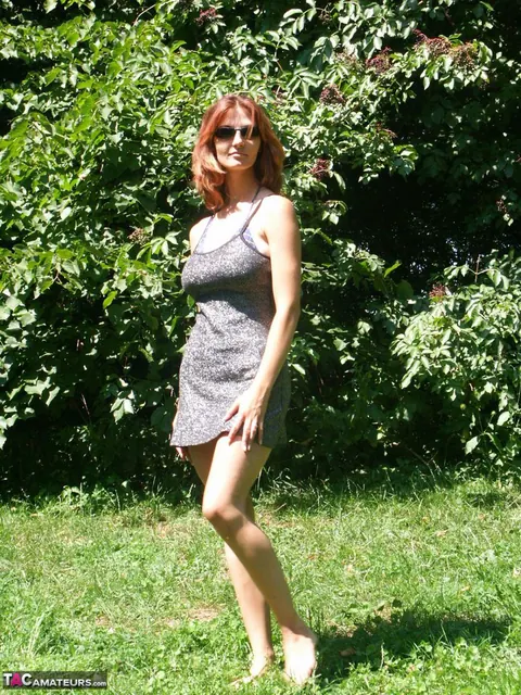Redhead MILF Strips Out of Her Bikini and Skirt Under a Tree – photo 1 of 20