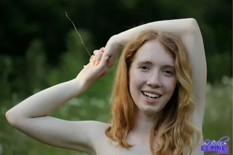 Nicki Blue: Redhead with Big Enhanced Tits Poses Nude in an Overgrown Field – photo 6 of 15