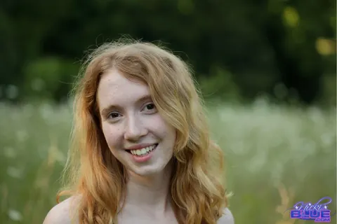 Nicki Blue: Redhead with Big Enhanced Tits Poses Nude in an Overgrown Field – photo 5 of 15