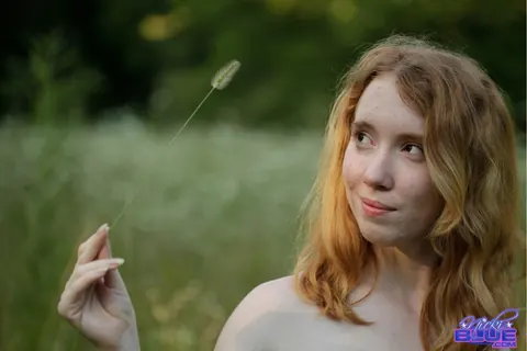 Nicki Blue: Redhead with Big Enhanced Tits Poses Nude in an Overgrown Field – photo 7 of 15