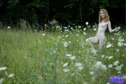 Nicki Blue: Redhead with Big Enhanced Tits Poses Nude in an Overgrown Field – photo 1 of 15