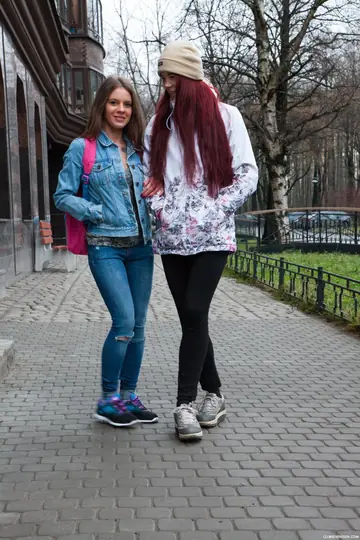 Two Brunettes in Jeans and Socks Share a Dildo