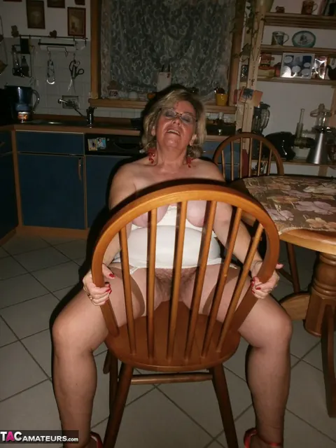 Curvy Mature Blonde in Stockings and Glasses Spreads in the Kitchen – photo 17 of 20
