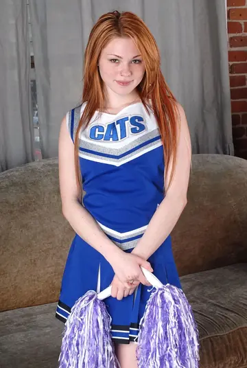 Redhead in Uniform Bares Her Tits and Fingers Her Pussy
