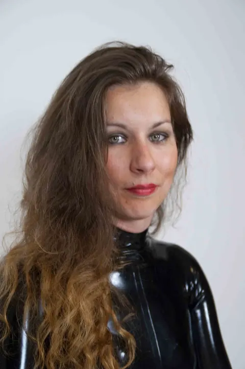 JANA PUFF: European Brunette in Latex Spanks a Male Sub with Her Lover – photo 4 of 17