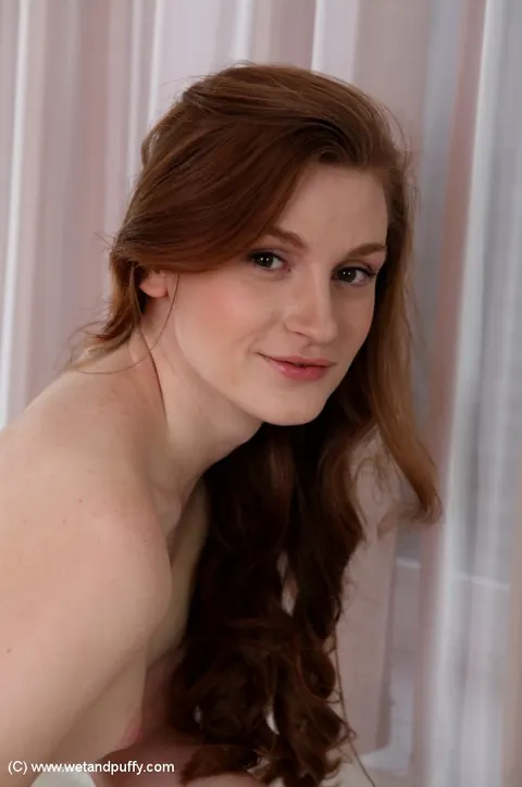 Ophelia H: Redhead Pulls Her Shorts Aside and Fingers Her Shaved Pussy – photo 11 of 16