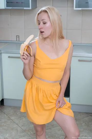 Slim Blonde Amateur Spreads Her Hairy Pussy and a Banana in the Kitchen