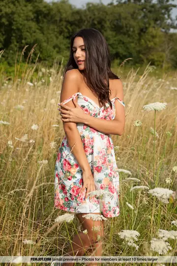 Slim European Brunette Bares Her Shaved Pussy in Open Field