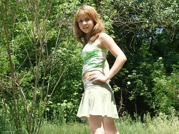 Outdoors, a European Woman with Big Tits Lifts Her Skirt and Spreads