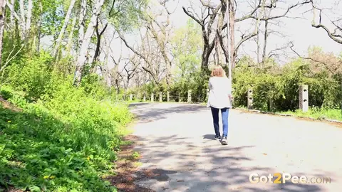 Woman in Jeans Squats and Spreads Outdoors – photo 15 of 15