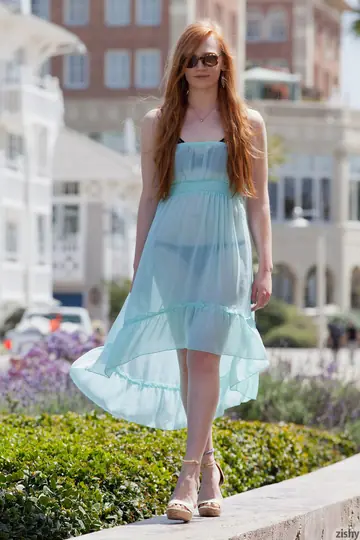 Redhead in Glasses Walks Outdoors in a See-Through Dress