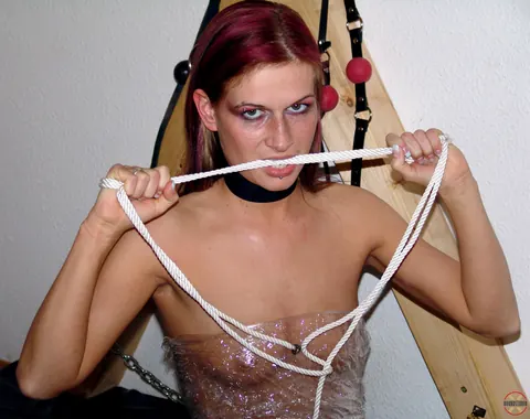 Redhead Wrapped in Latex Poses on a Cross – photo 3 of 16
