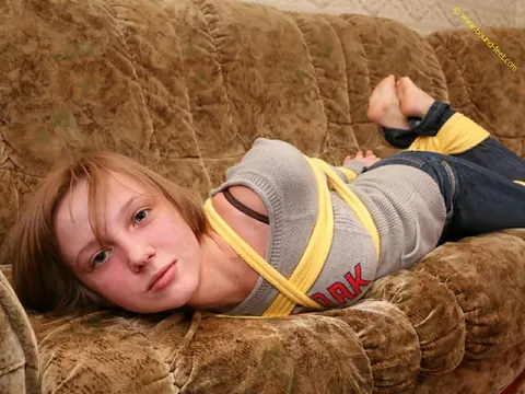 Short-Haired Woman Hogtied in Jeans on the Sofa – photo 3 of 16
