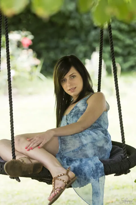 Daniela Rose: Slim Brunette Spreads Her Shaved Pussy Outdoors on a Swing – photo 4 of 17