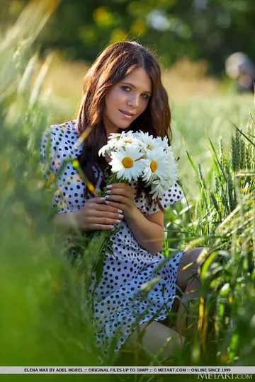 European Brunette Picks Wildflowers and Spreads Outdoors