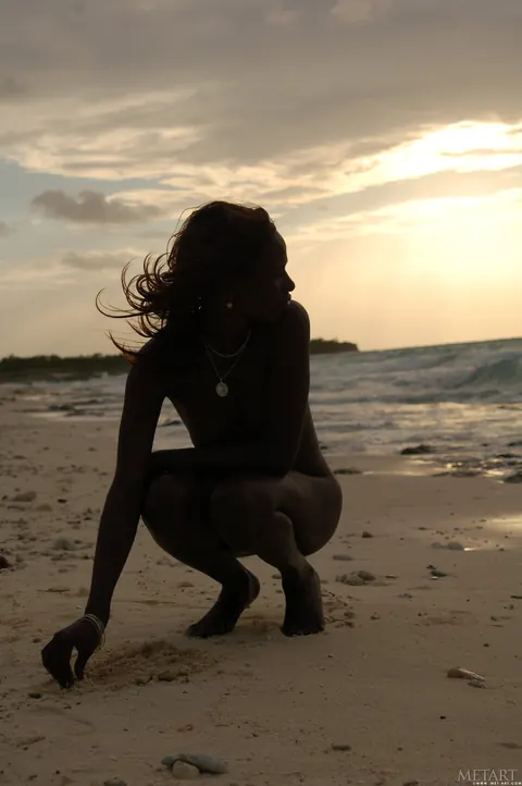 Slim Ebony Redhead Undresses and Poses Nude on the Beach – photo 4 of 21