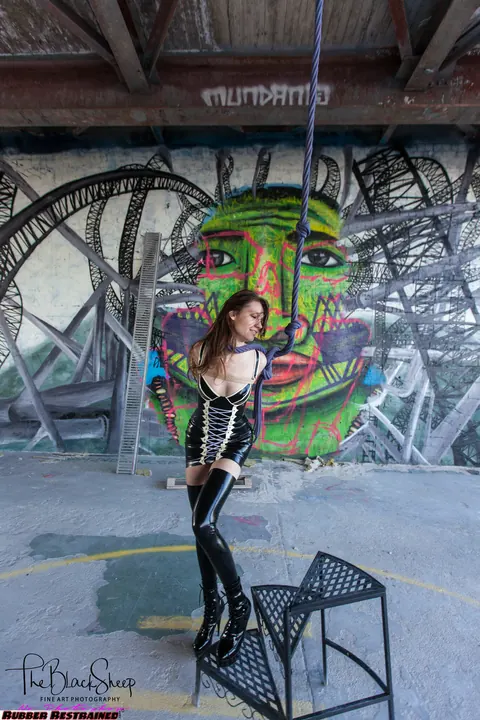 Fetish Model in a Latex Skirt and Stockings Is Restrained – photo 15 of 16
